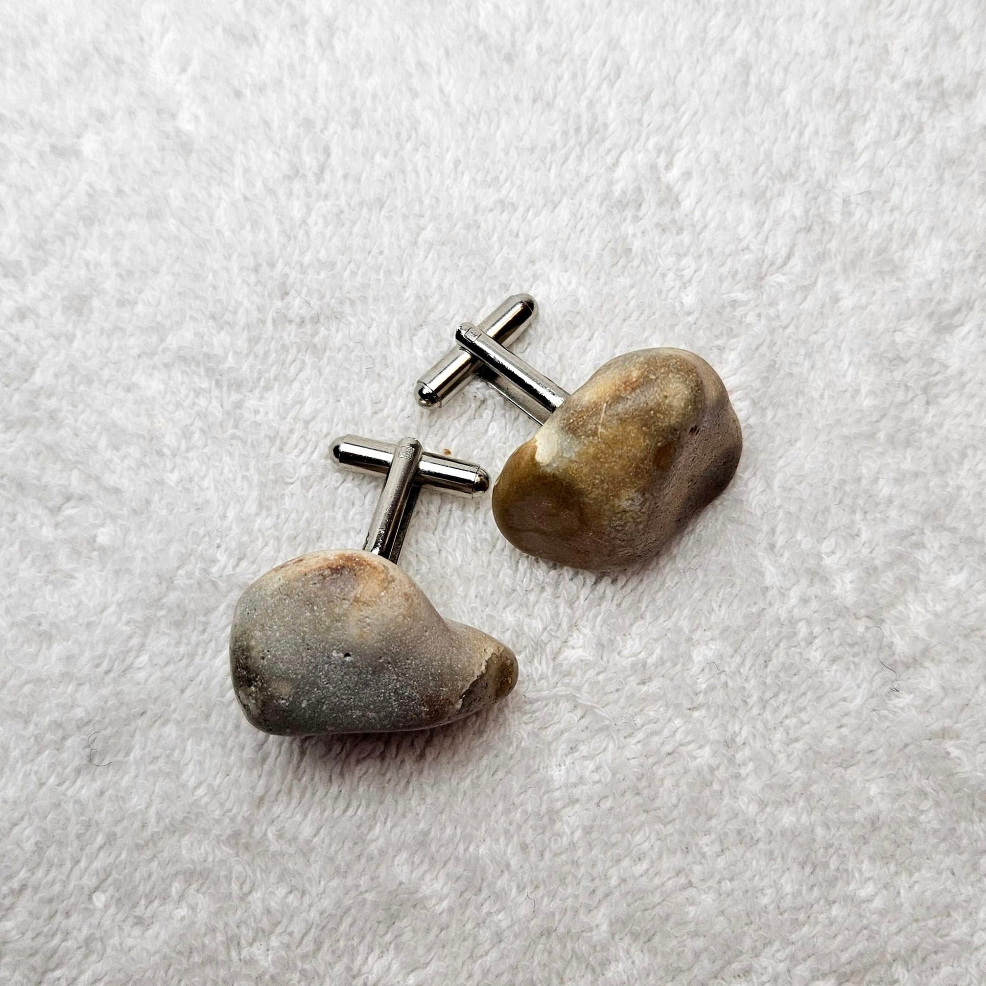 Image shows Brighton Rocks! Cufflinks designed by barnardandjestico . Stylish Cufflinks of natural polished stone ; from handmade process at my studio in Brighton Sussex England. For Menswear to show individual flair . Bold-sized ( 2-to-4cm ) natural shaped stones specialist-waxed and polished , then set on steel-studs . Homemade artisan methods of natural environmental materials