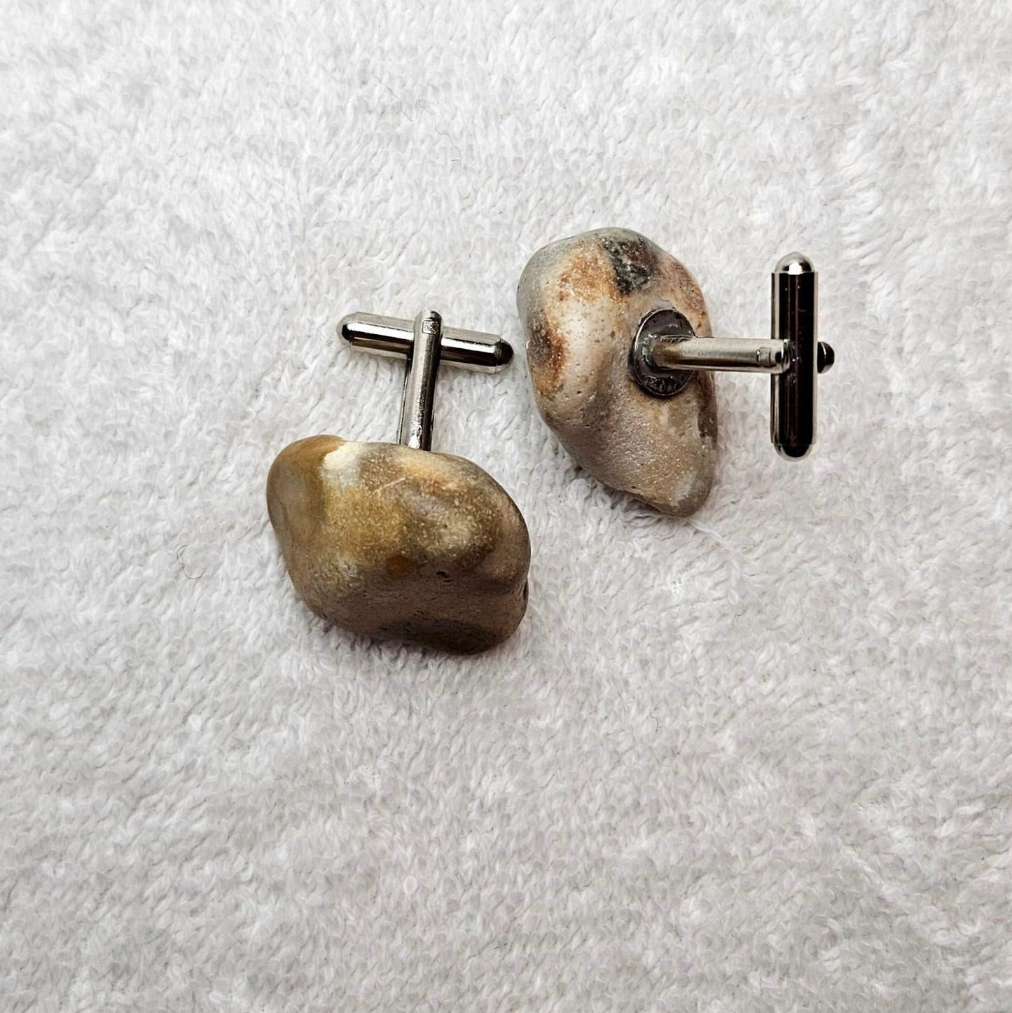 Image shows Brighton Rocks! Cufflinks designed by barnardandjestico . Stylish Cufflinks of natural polished stone ; from handmade process at my studio in Brighton Sussex England. For Menswear to show individual flair . Bold-sized ( 2-to-4cm ) natural shaped stones specialist-waxed and polished , then set on steel-studs . Homemade artisan methods of natural environmental materials